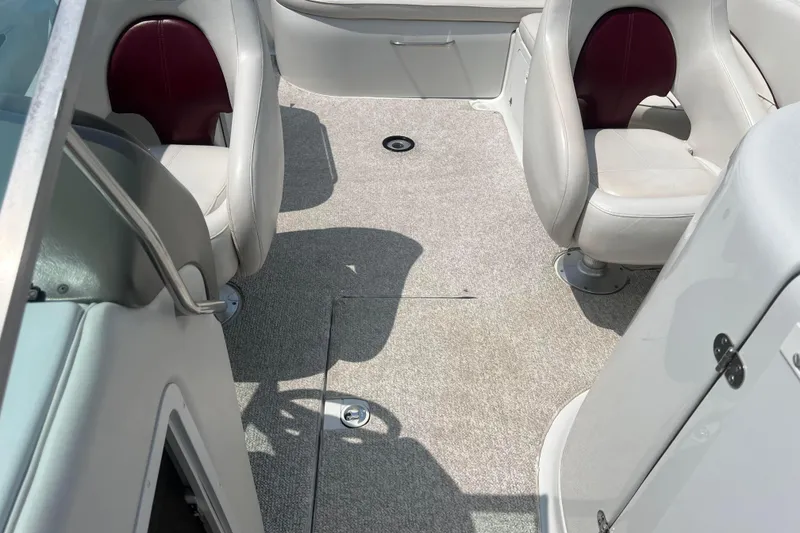Slide: The Image of Interior of 2003 Crownline 230 BR boat with gray carpet and white seats. - 55