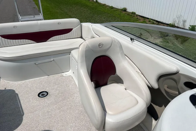 Slide: The Image of 2003 Crownline 230 BR boat interior with white and maroon seating, carpeted floor. - 59