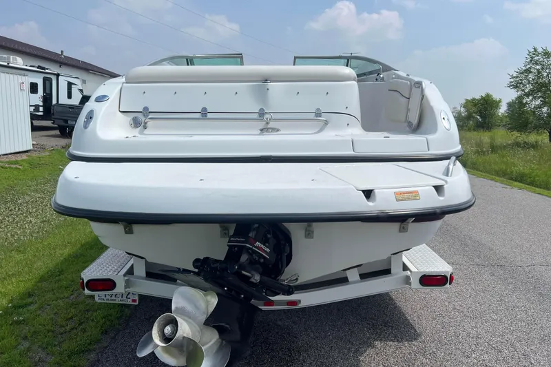 Slide: The Image of 2003 Crownline 230 BR boat rear view with trailer on a sunny day. - 6