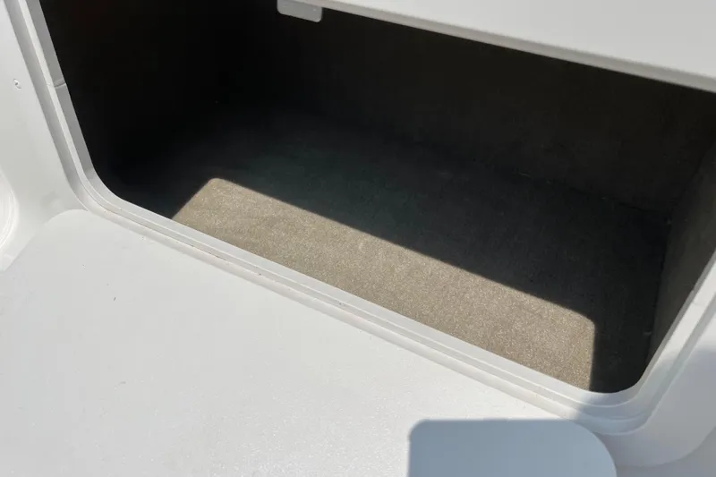 Slide: The Image of Storage compartment in 2003 Crownline 230 BR boat, featuring a clean, spacious interior. - 61