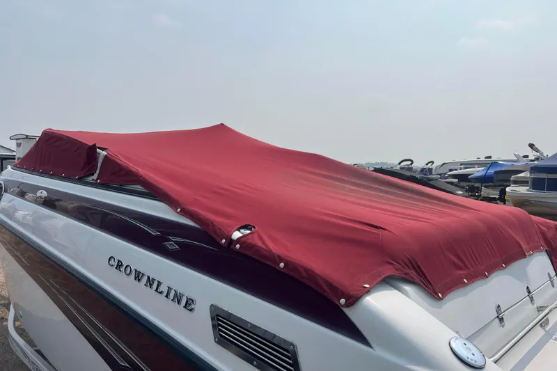 Slide: The Image of 2003 Crownline 230 BR boat with red cover docked at marina. - 69