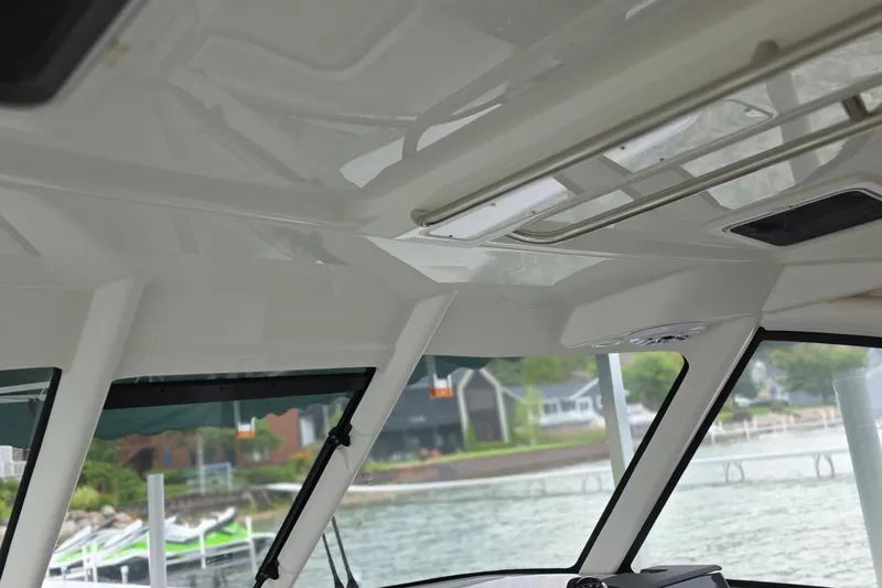 Slide: The Image of 2024 Pursuit DC 326 Dual Console interior view with water and dock in background. - 10