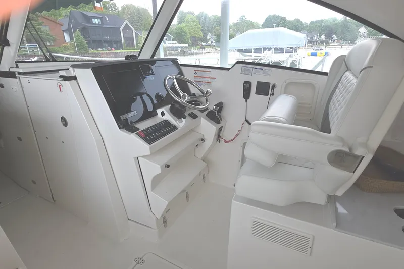 Slide: The Image of 2024 Pursuit DC 326 Dual Console helm with modern controls and comfortable seating. - 16