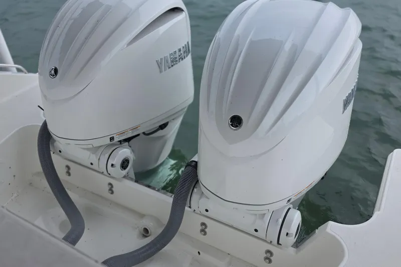 Slide: The Image of 2024 Pursuit DC 326 Dual Console with twin Yamaha outboard engines on water. - 32