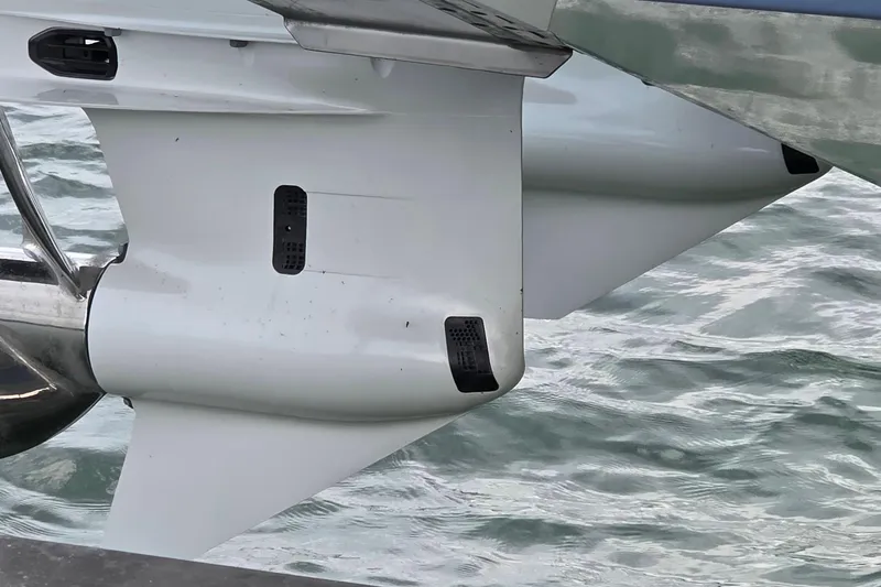 Slide: The Image of 2024 Pursuit DC 326 Dual Console boat engine detail on water. - 33