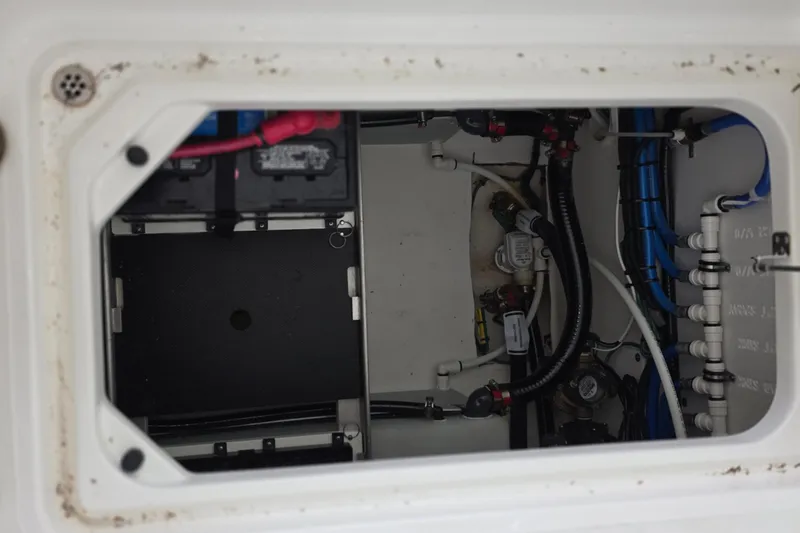 Slide: The Image of 2024 Pursuit DC 326 Dual Console boat wiring and battery compartment. - 35