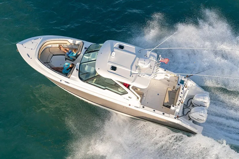 Slide: The Image of Manufacturer Provided Image: 2024 Pursuit DC 326 Dual Console boat cruising on water. - 4