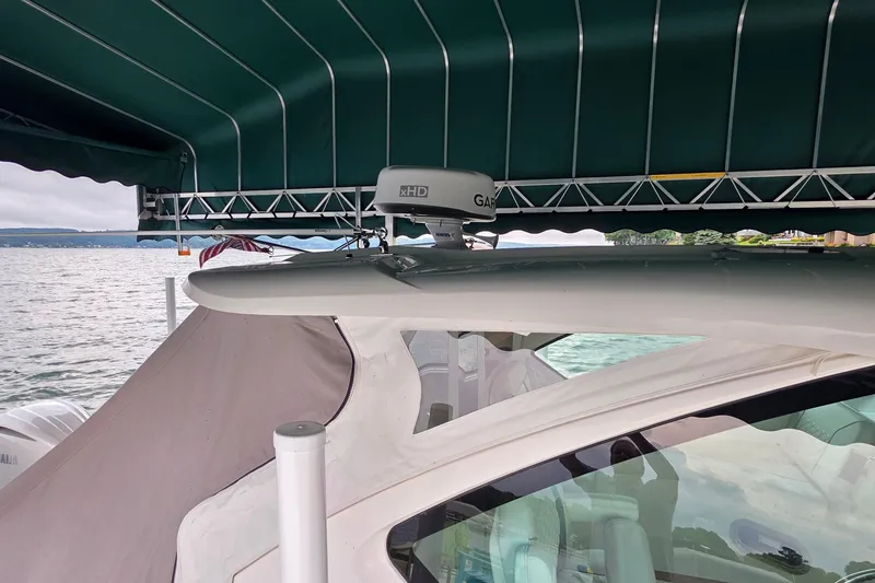 Slide: The Image of 2024 Pursuit DC 326 Dual Console boat under canopy with Garmin radar. - 7