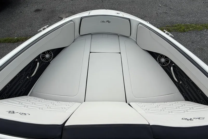 Slide: The Image of 2025 Sea Ray SPX 190 boat interior with white cushioned seating and speakers. - 11