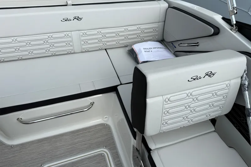 Slide: The Image of 2025 Sea Ray SPX 190 boat interior with white cushioned seating and branded embroidery. - 8