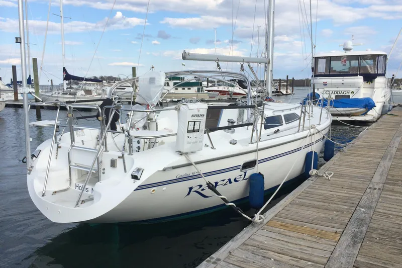 Slide: The Image of 1998 Catalina 36 MkII sailboat docked at marina, clear sky, calm water. - 1