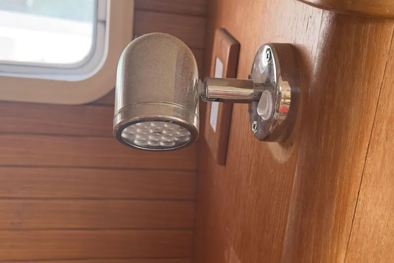 Slide: The Image of Interior light fixture on a 1998 Catalina 36 MkII sailboat, mounted on wooden paneling. - 10