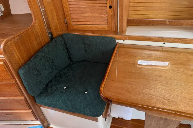 Slide: The Image of Cozy seating area with wooden table in 1998 Catalina 36 MkII sailboat. - 14