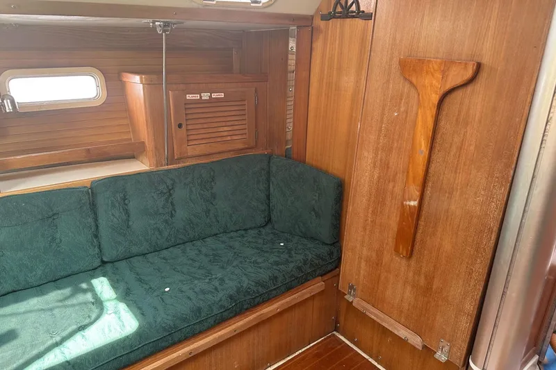 Slide: The Image of Interior of 1998 Catalina 36 MkII sailboat with green cushioned seating and wooden cabinetry. - 15