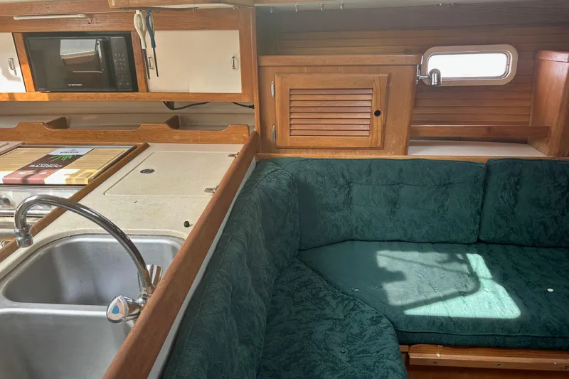 Slide: The Image of Interior of 1998 Catalina 36 MkII sailboat with green upholstery and wooden cabinetry. - 17