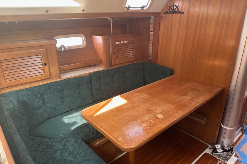 Slide: The Image of Interior of 1998 Catalina 36 MkII sailboat with wooden table and green seating. - 18