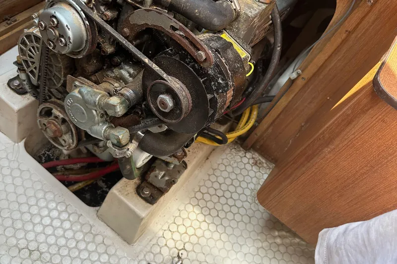 Slide: The Image of Engine compartment of a 1998 Catalina 36 MkII sailboat, showing mechanical components. - 23