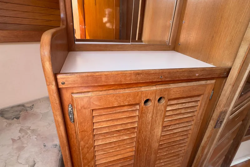 Slide: The Image of Wooden cabinet with louvered doors inside a 1998 Catalina 36 MkII sailboat. - 5