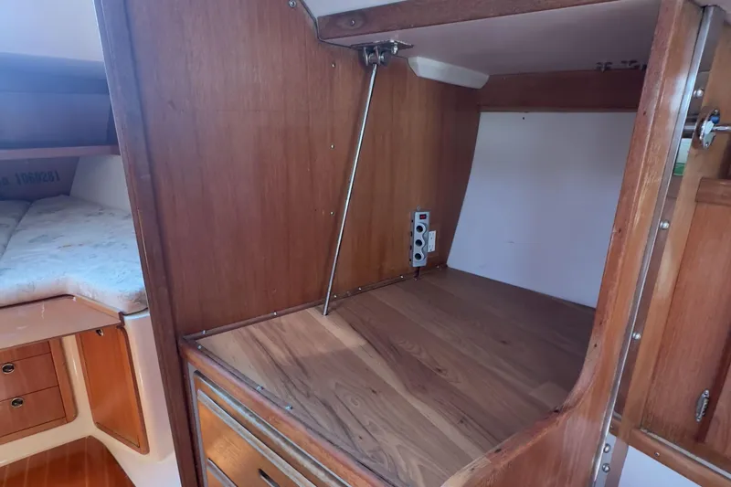 Slide: The Image of Interior of 1998 Catalina 36 MkII sailboat with wooden cabinetry and sleeping area. - 7