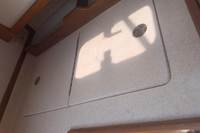 Slide: The Image of Interior of 1998 Catalina 36 MkII sailboat, featuring a countertop with wooden trim. - 9