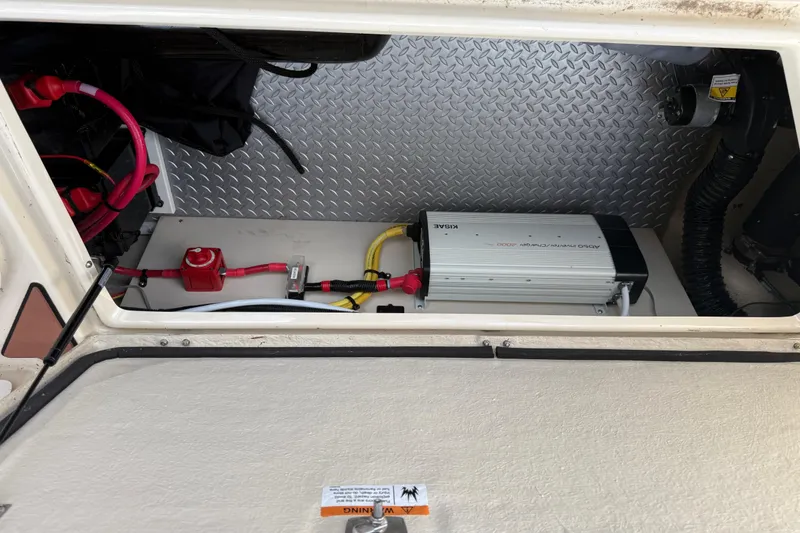 Slide: The Image of 2024 Ranger Tugs R31CB electrical compartment with inverter and wiring. - 15