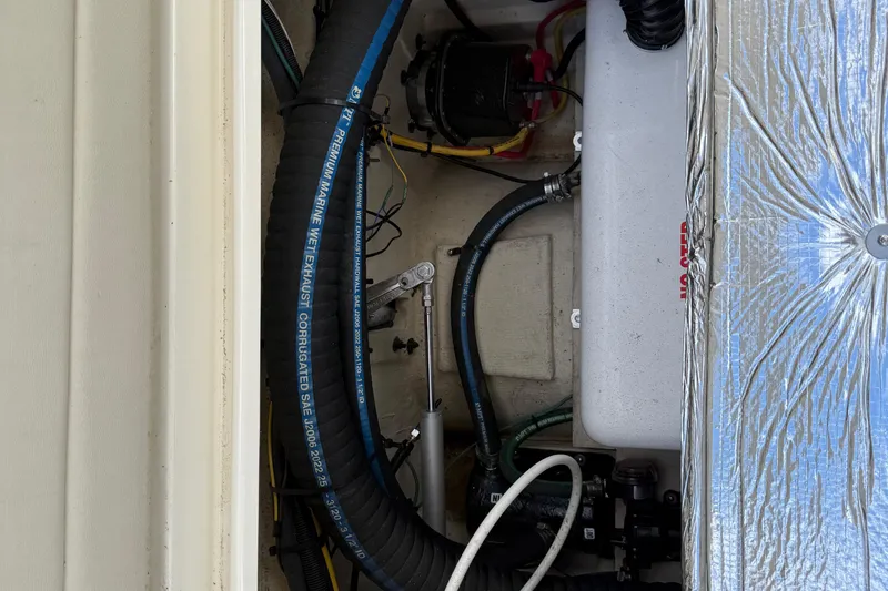 Slide: The Image of Engine compartment of 2024 Ranger Tugs R31CB with marine exhaust system. - 17