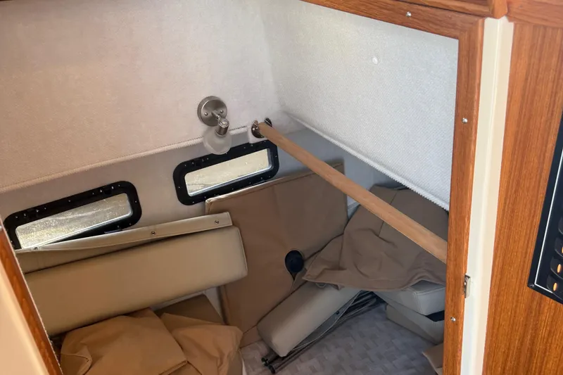 Slide: The Image of 2024 Ranger Tugs R31CB interior cabin with windows and seating area. - 20