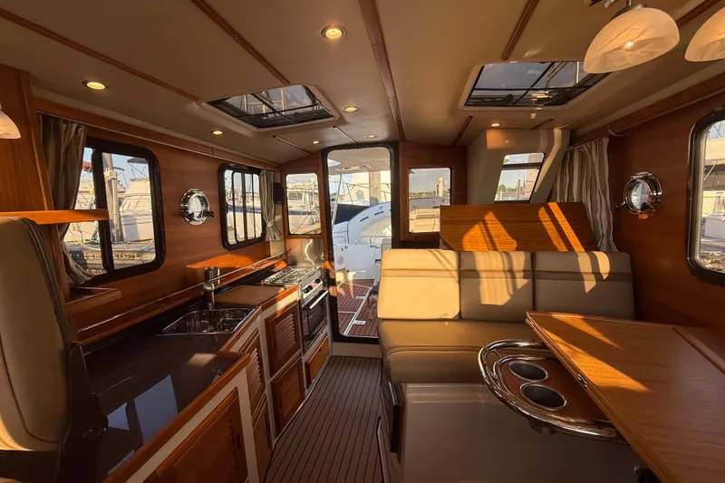Slide: The Image of Luxurious interior of 2024 Ranger Tugs R31CB boat with elegant wood finishes. - 22