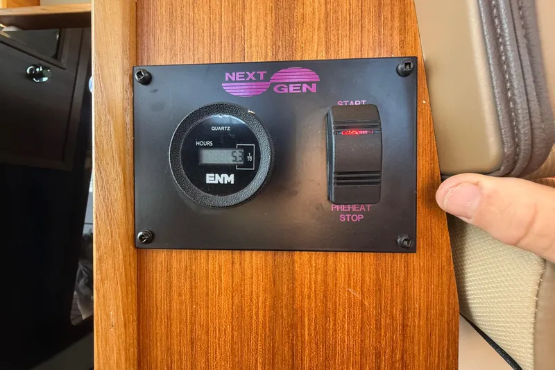 Slide: The Image of Control panel of 2024 Ranger Tugs R31CB with hour meter and start switch. - 28