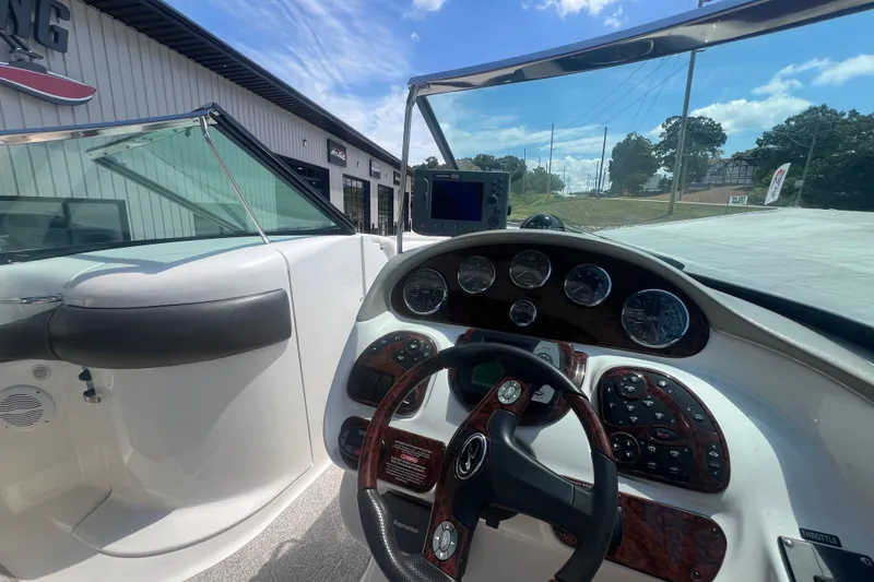 Slide: The Image of 2005 Sea Ray 290 SLX boat dashboard with steering wheel and navigation instruments. - 12