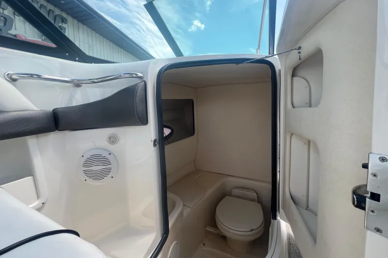 Slide: The Image of Interior view of 2005 Sea Ray 290 SLX boat's compact bathroom with toilet. - 13