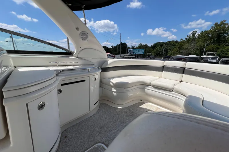 Slide: The Image of 2005 Sea Ray 290 SLX boat interior with white seating and storage compartments. - 16