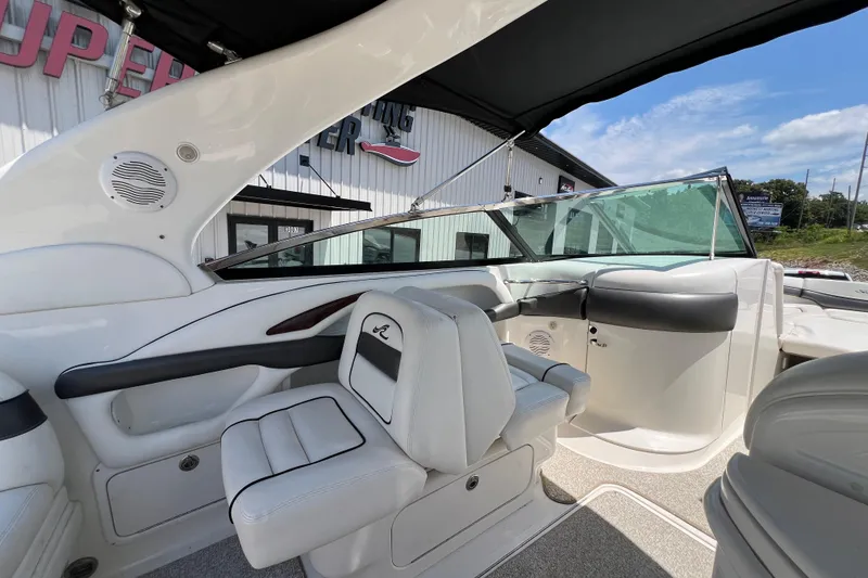 Slide: The Image of 2005 Sea Ray 290 SLX boat interior with white seating and sleek design. - 18