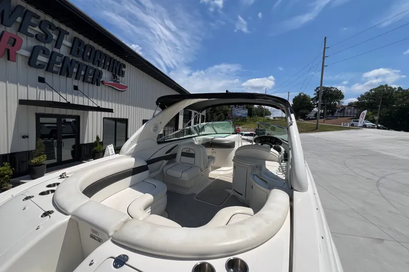 Slide: The Image of 2005 Sea Ray 290 SLX boat at West Boating Center, showcasing luxurious seating and helm. - 19