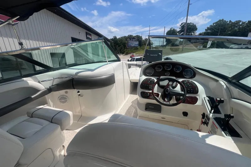 Slide: The Image of Interior view of 2005 Sea Ray 290 SLX boat cockpit with steering wheel and controls. - 5