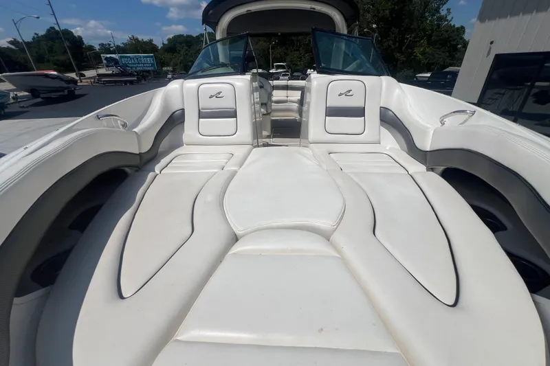 Slide: The Image of 2005 Sea Ray 290 SLX boat with spacious white seating and open deck. - 8