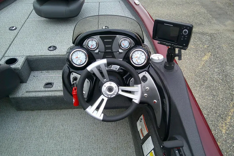 Slide: The Image of 2021 Tracker Pro Team 175 TXW Tournament Edition boat dashboard with steering wheel and gauges. - 7