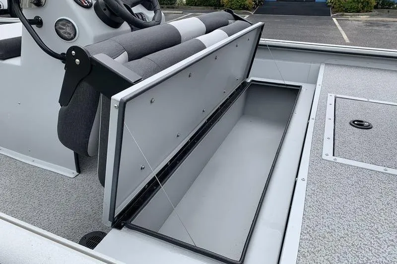 Slide: The Image of 2026 SeaArk Shadow 18 Center Console boat with open storage compartment. - 11