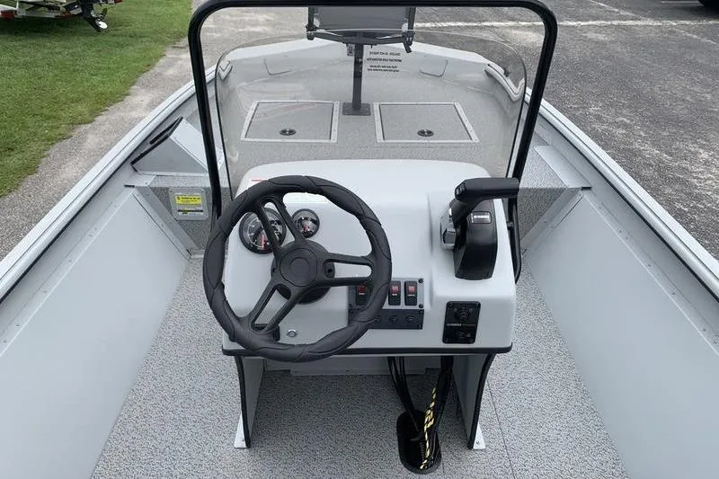 Slide: The Image of 2026 SeaArk Shadow 18 Center Console boat interior with steering wheel and controls. - 13