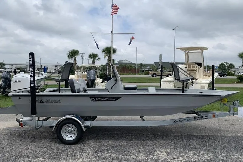 Slide: The Image of 2026 SeaArk Shadow 18 Center Console boat on trailer, parked outdoors. - 5
