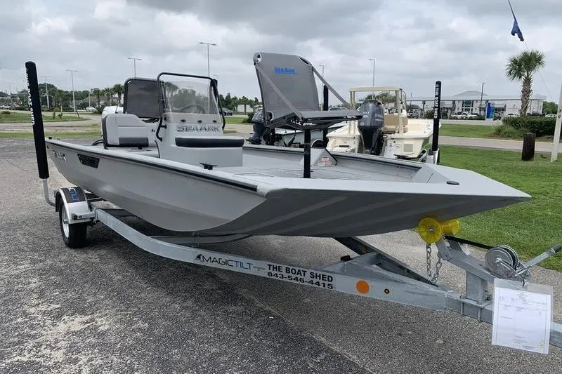 Slide: The Image of 2026 SeaArk Shadow 18 Center Console boat on trailer, parked outdoors. - 6