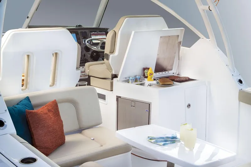 Slide: The Image of Interior of 2019 Pursuit DC 325 Dual Console boat with seating and kitchenette. - 100