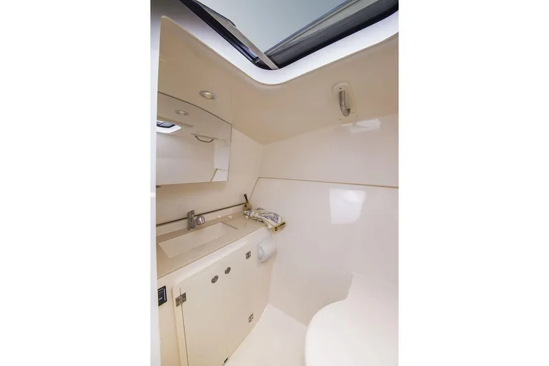 Slide: The Image of 2019 Pursuit DC 325 Dual Console boat interior bathroom with sink and mirror - 102