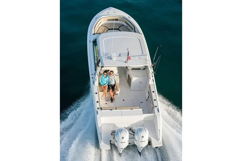 Slide: The Image of 2019 Pursuit DC 325 Dual Console boat cruising on water. - 96