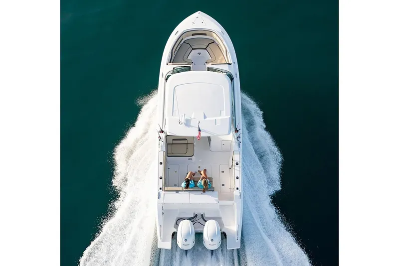 Slide: The Image of 2019 Pursuit DC 325 Dual Console boat cruising on open water. - 97