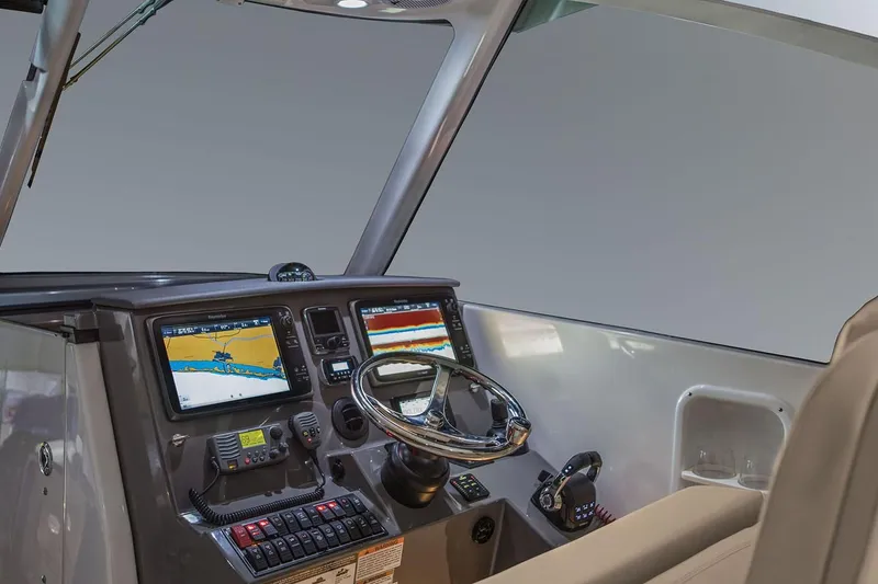 Slide: The Image of 2019 Pursuit DC 325 Dual Console helm with navigation screens and steering wheel. - 98