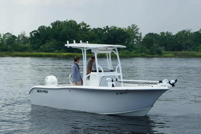 The Image of 2020 Sea Pro 219 Center Console boat on calm water with two people onboard. - 0