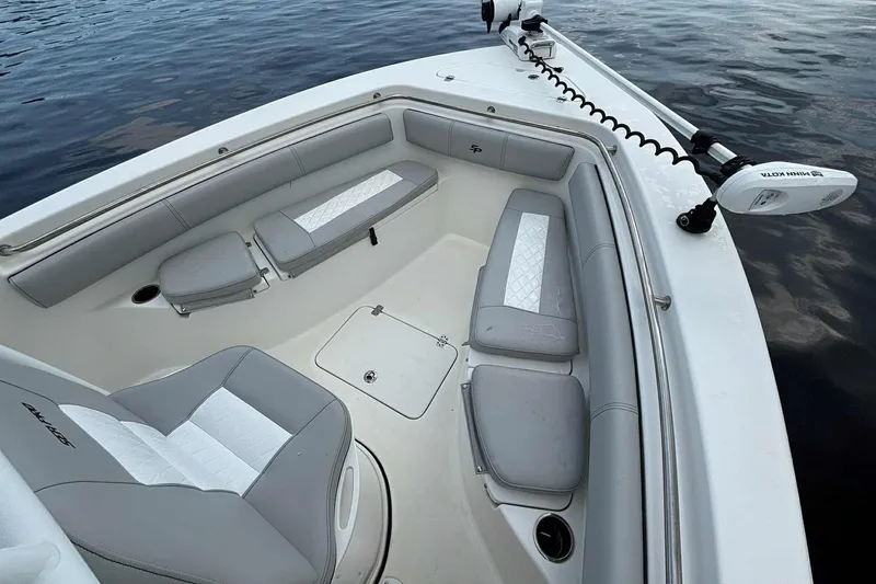 Slide: The Image of 2020 Sea Pro 219 Center Console boat interior with cushioned seating and trolling motor. - 16