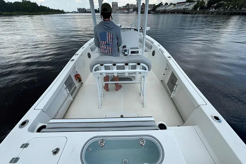 Slide: The Image of 2020 Sea Pro 219 Center Console boat on calm water, person at helm. - 19
