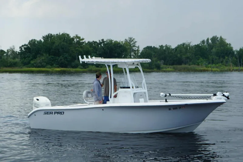 Slide: The Image of 2020 Sea Pro 219 Center Console boat on calm water with two people onboard. - 2